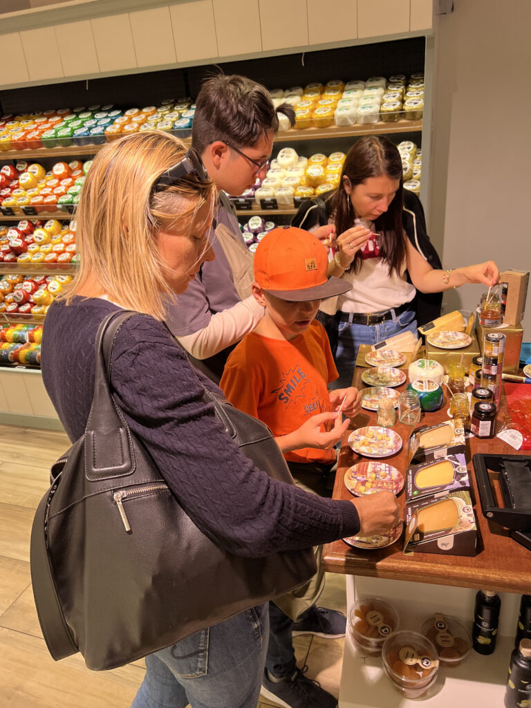 Dutch cheese — tasting farm Gouda before buying in a shop